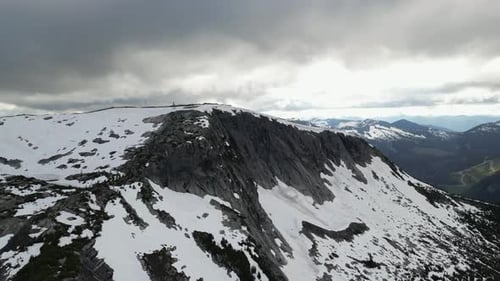 Dramatic Rocky Peak with Snow, Moody Sky. Dark Clouds, Mountain Landscape. Canadian Nature, British