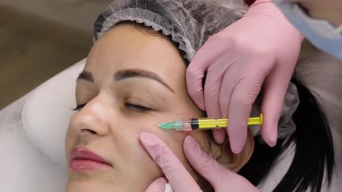 Woman Receiving Cosmetic Injection in Clinic