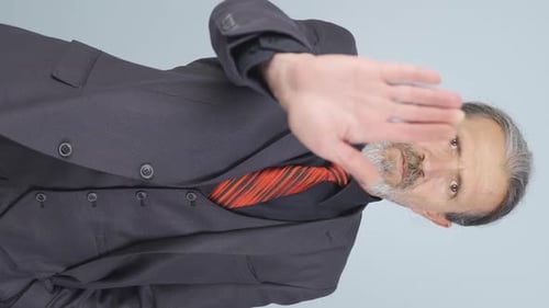 Man in Suit Gesturing Stop with Hand