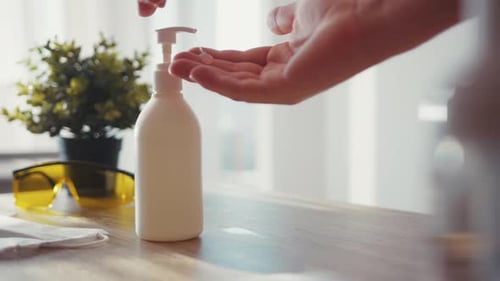 Close Up Man Push Dispenser and Liquid Antiseptic Out to Hand Wash your Hands Stay at Home