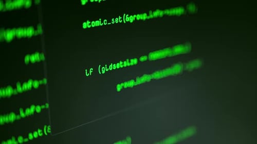 Close up shot of green computer code typing onto screen. Computer hacker.