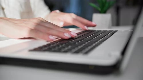Hands Typing on Laptop Keyboard Close Up