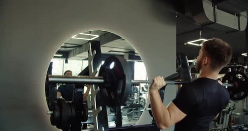 Man Fitness and Weightlifting Barbell in Workout Exercise or Training for Muscle Gain at Indoor Gym