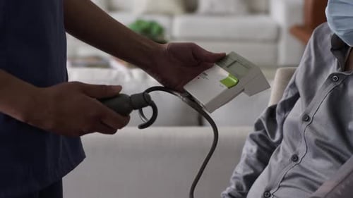 Senior Man Blood Pressure Checked by Medical Professional