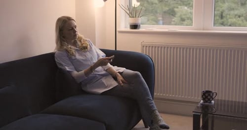 Woman watching tv, news media and movie, cable show and broadcast in home lounge