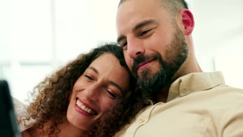 Affectionate Couple Watching Tablet at Home