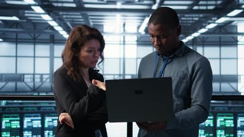 Engineers Using Laptop in Data Center Managing Server Virtualization