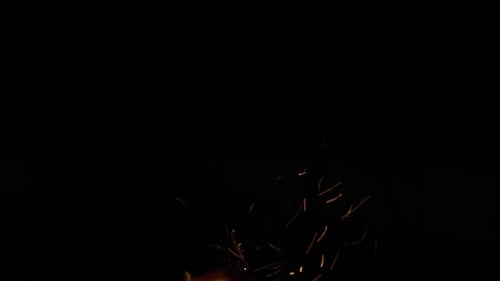 Glowing Fire Embers Rising in the Night