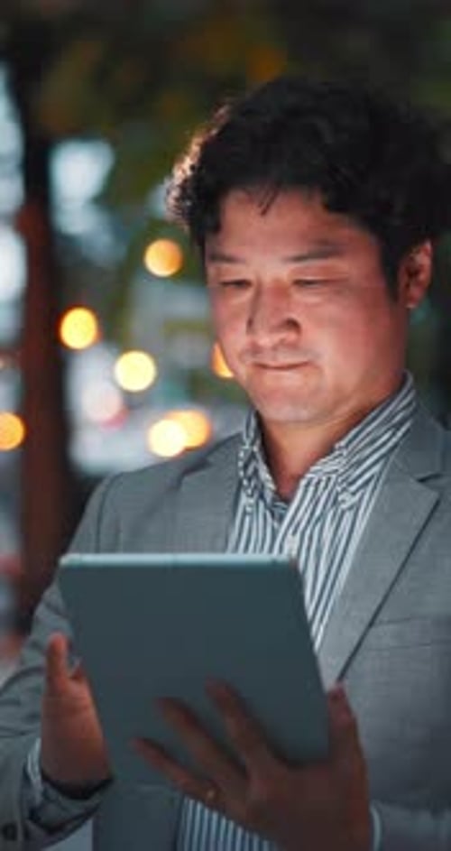 Online, night and Asian man on tablet in city for communication, typing email and networking