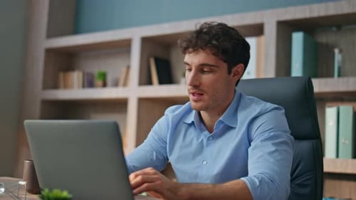 Man working from home closes laptop smiling