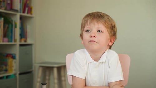 Child Sitting at Table Indoors during Daytime