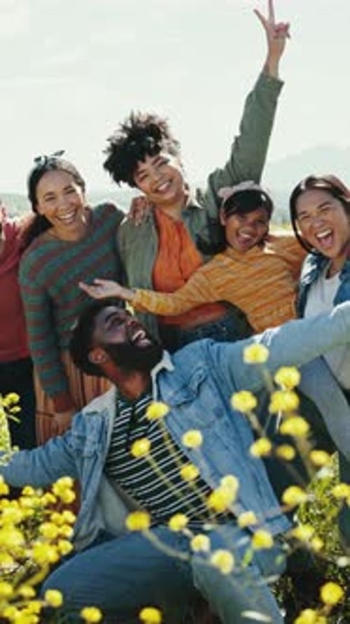 Friends Laughing Together in a Field of Flowers