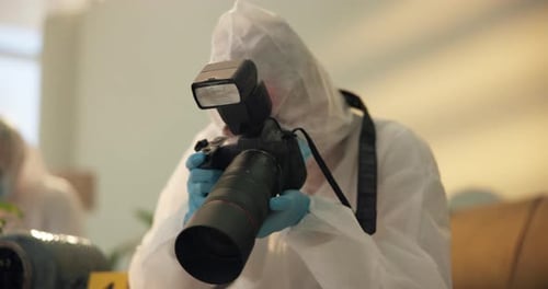 Forensic Investigator Taking Photos at Indoor Crime Scene