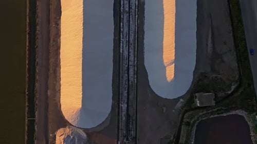 Aerial view of serene salt pans at sunset, Greece.