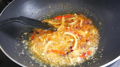 Food Cooking in a Pan on a Stove