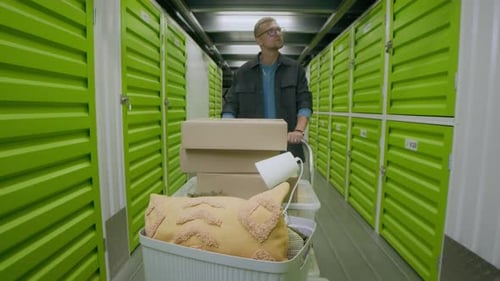Homme organisant ses affaires dans une installation de stockage en libre-service Bright Green