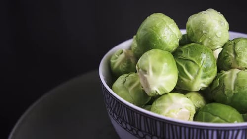 Extreme Close Up of Fresh Brussel Sprouts rotating on black background