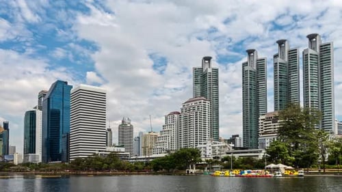 Modern City Skyline with Reflective Water and Lush Greenery in Bangkok