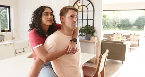Affectionate Couple Embracing in Modern Kitchen