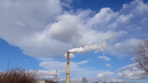 Smoke Coming Out From Industrial Chimney Stack With Blue Sky And Clouds In Background. - timelapse