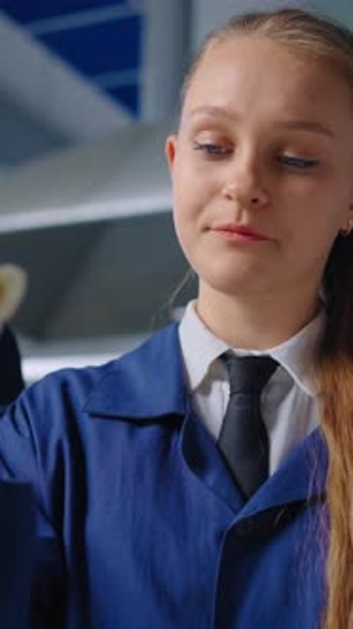 Young Woman Scientist Inspecting Test Tube in Laboratory