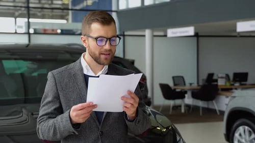 Seller Examines Cars Sales Documents