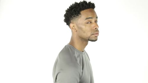 Black and fit Afro-american in his 20s man in studio a white background