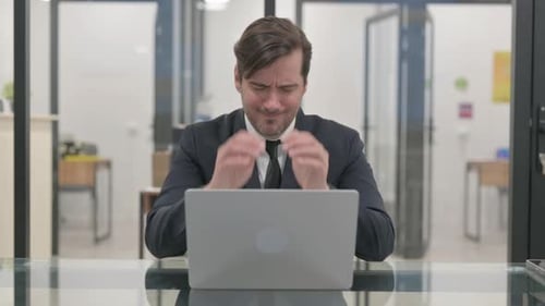 Mature Businessman with Migraine in Office