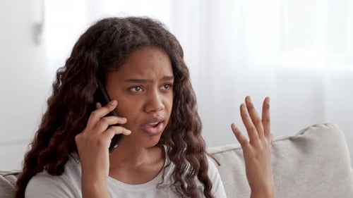 Teen Girl Having a Phone Conversation at Home in a Cozy Living Room