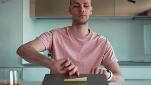 Man Working at Laptop in Modern Kitchen