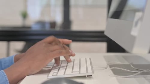 Close up of African Man Typing on Keyboard