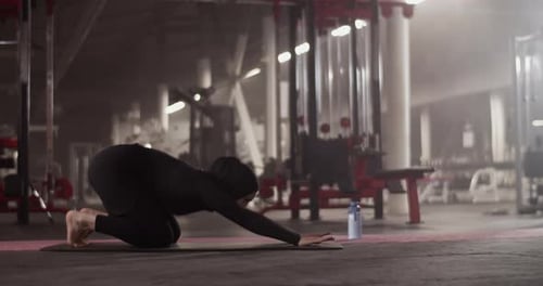 Muslim Sportswoman Stretching Back in Gym