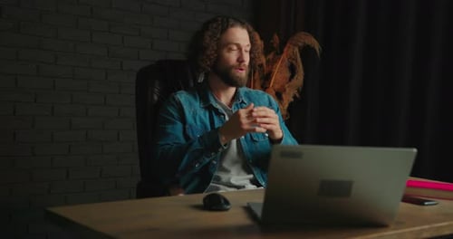 Man Talking in Front of a Computer