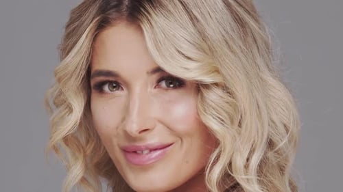 Studio Portrait of Young and Beautiful Blond Woman Over Grey Background Skin Care and Wellness