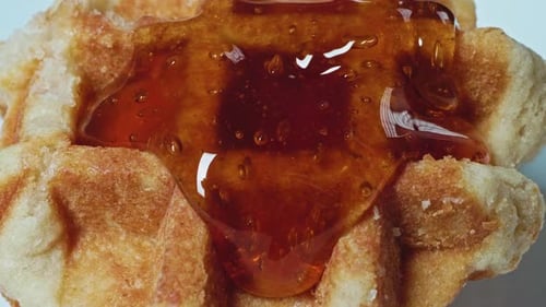 Syrup Flows Over a Crispy Golden Waffle