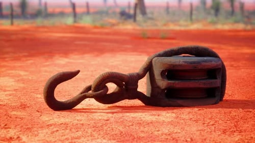 A Rusty Metal Hook on a Vibrant Red Dirt Road