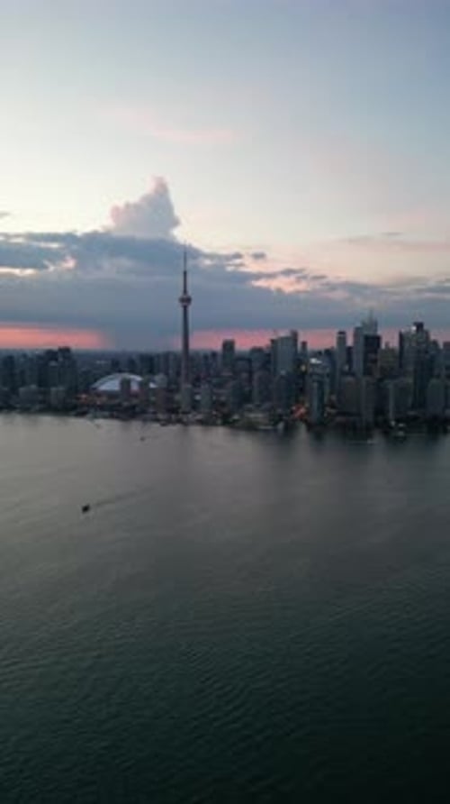 Aerial shot of downtown Toronto with the CN Tower towering into the sky, at night. in Canada