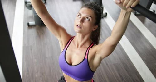 Woman Doing Exercise for Her Back in the Gym