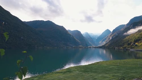 Camera panning from left to right, showing a beautiful scenery of a big lake surrounded by mountains