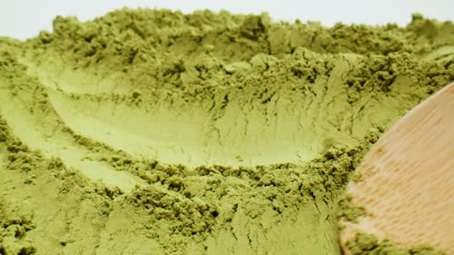 Matcha Green Tea Cooking Process Japanese Powder Green Tea in a Bowl with Bamboo Whisk Macro Close