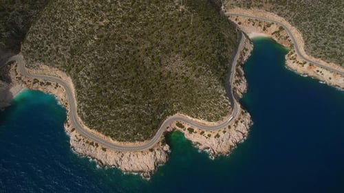 A Car Drives Along the Road Along the Mediterranean Sea