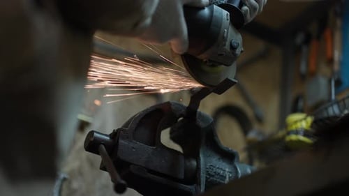 Worker Cutting Metal Tube Using an Angle Grinder Bright Sparks and Flashes