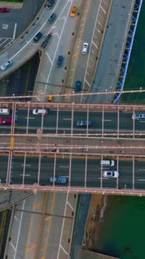 Busy traffic of big city. Multiple cars running through the roads and bridges at daytime.
