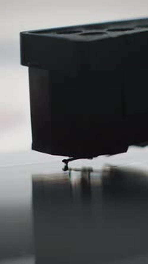 Macro Close Up of Stylus Needle Touching Grooves Playing Melody on Vinyl Record Player