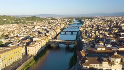 Cinematic Establishing Shot Above Iconic Ponte Vecchio Bridge in Florence at Sunrise