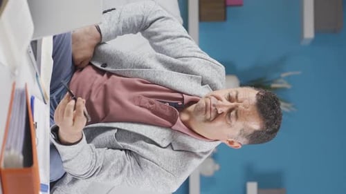 Vertical video of Home office worker old man freelancing.