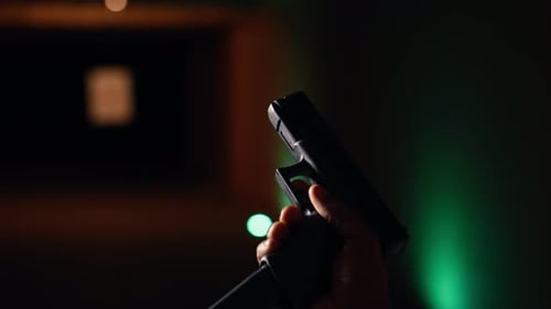Man Reloading Handgun in Indoor Shooting Range Close Up