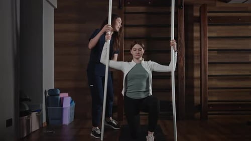 Medical Sports Rehabilitation After Injury and Surgery A Medical Trainer Works with a Patient Under