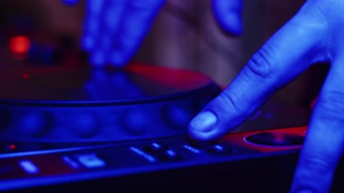 Male Hand of Professional DJ Turns Disc on DJ Stereo Control for Sound Quality and Frequencies