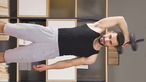 Man Lifting Dumbbell Bicep Curls in Home Setting